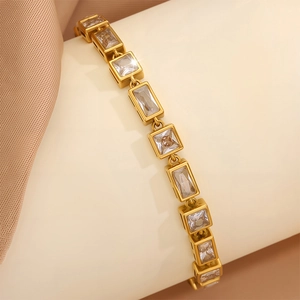 Detail of gold-plated stainless steel bracelet featuring radiant square cubic zirconia stones