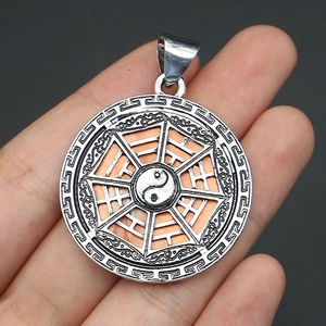 Detailed view of a silver alloy circular Bagua pendant with colored shell inlay details