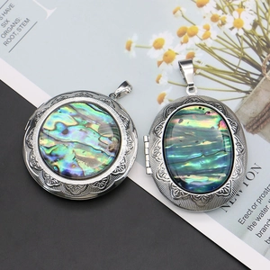 Vintage round and oval abalone shell locket pendants with embossed copper floral design