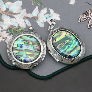 Vintage round and oval abalone shell locket pendants with silver floral engraving