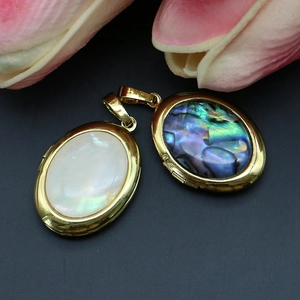 Oval locket pendant with natural shell and abalone inlay on a golden frame
