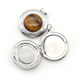 Vintage round locket pendant with tiger eye stone and intricate floral relief patterns
