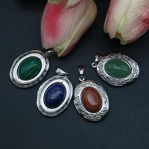 Vintage oval locket pendants with engraved floral patterns and colorful natural stones