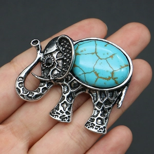 Detailed view of elephant brooch with turquoise stone and vintage silver texture