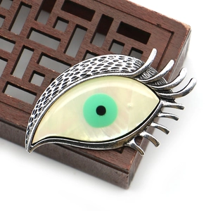 Vintage silver evil eye brooch with natural mother of pearl inlay and green pupil