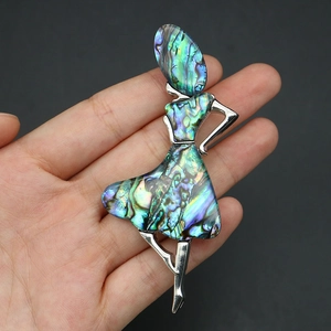 Detail view of dancer brooch with iridescent abalone shell inlay and silver finish