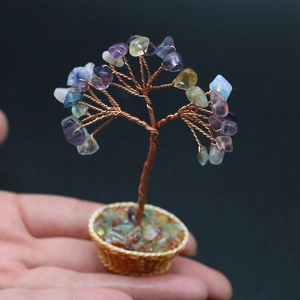 Macro detail of a handmade mini crystal tree with twisted copper wire in a woven basket