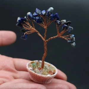 Macro detail of a handcrafted blue lapis crystal money tree in a mini woven flower basket