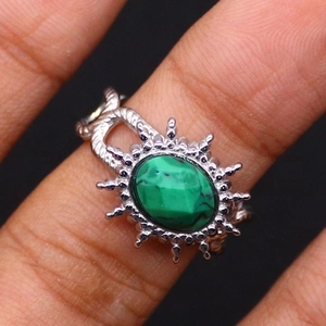 Macro shot of oval green gemstone ring with a vintage woven stainless steel band