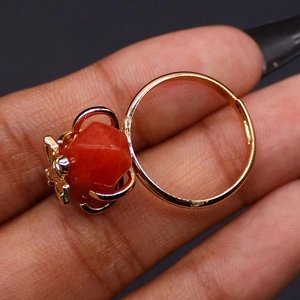 Macro view of gold honeybee ring featuring a faceted orange gemstone and detailed claw setting