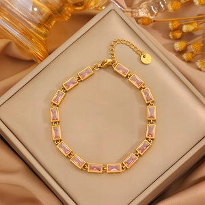 Close-up of gold stainless steel bracelet featuring rectangular pink cubic zirconia stones