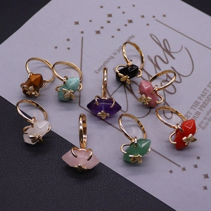 Set of nine golden bee rings with assorted hexagonal crystal gemstone prisms