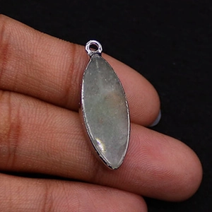 Close-up of a marquise-shaped natural stone pendant with silver-plated edging
