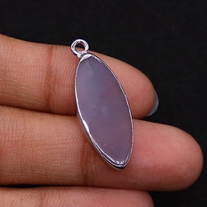 Macro detail of marquise lavender natural stone pendant with silver plated bezel on hand