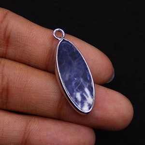 Close-up of a natural blue sodalite stone pendant with silver plated bezel and bail