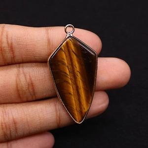Detailed view of shield-shaped tiger eye stone pendant with rose gold plated edging