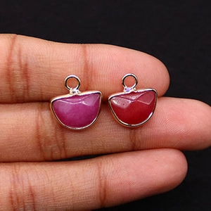 Detail of rose and red faceted stone pendants with gold plating for jewelry making