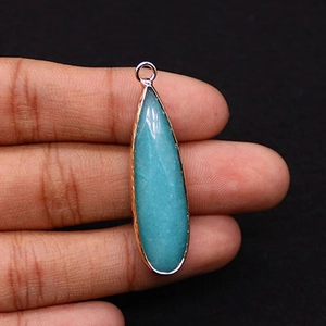 Detailed close-up of a blue teardrop natural stone pendant with a gold electroplated rim