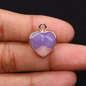 Vue détaillée d'un pendentif en pierre violette en forme de cœur avec bords dorés