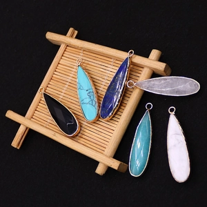 Set of six colorful teardrop natural stone pendants with gold metal plated edges