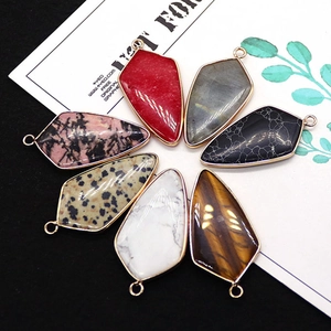 Set of seven natural stone shield pendants with golden electroplated metal edges