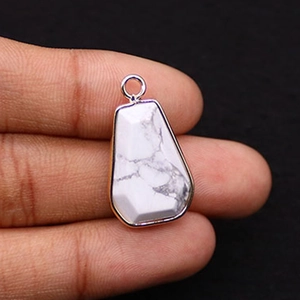 Close-up of trapezoid white turquoise pendant with silver plated bezel and bail