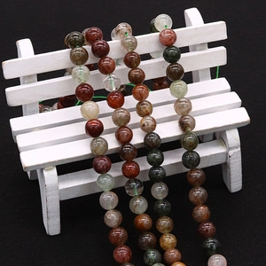 Polished natural Rutilated Quartz and Phantom Quartz round loose beads on mini chair