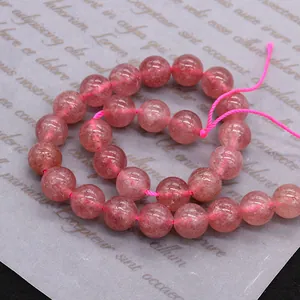 Polished natural pink strawberry quartz beads in a spiral arrangement for jewelry DIY