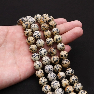Natural Dalmatian Jasper round beads for DIY jewelry making displayed in hand