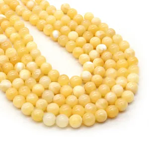 Strands of round yellow pearls with iridescent luster for DIY jewelry making and necklaces