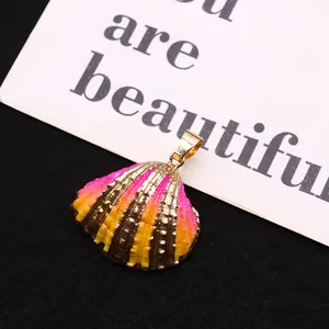 Macro detail of natural shell pendant with gold electroplated edge and colorful gradient