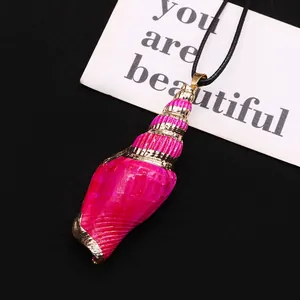 Detailed close-up of bright pink seashell pendant with gold-plated edges on black rope