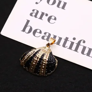 Natural dyed shell snail pendant with gold plated edges and elegant black texture