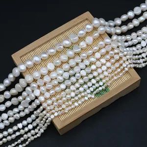 Natural freshwater baroque pearls in various sizes on a bamboo tray for DIY jewelry