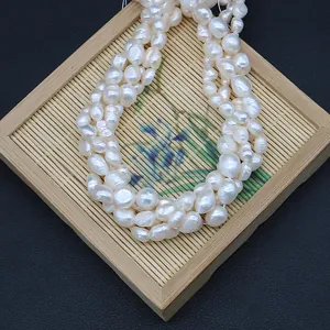 Natural baroque freshwater pearls displayed on a bamboo tray for DIY jewelry making