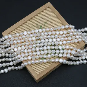 Natural white baroque freshwater pearl strands for DIY jewelry making on bamboo tray