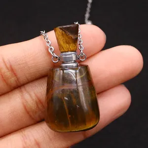 Ätherisches Ölflaschen-Anhänger aus Tigerauge mit Metallkette in der Hand gehalten