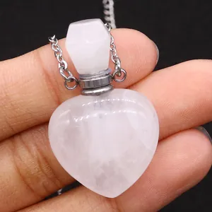 Macro shot of heart-shaped rose quartz perfume bottle pendant with a silver metal chain