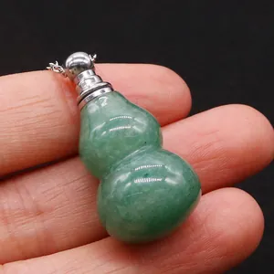 Macro view of a green jade gourd-shaped perfume bottle pendant with silver chain