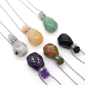 Macro detail of geometric faceted natural stone perfume bottles and silver link chains