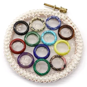 Collection of 12 colorful natural stone rings including amethyst and tiger eye on lace