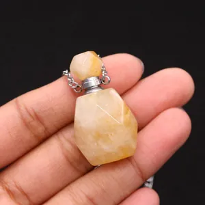 Macro shot of yellow citrine stone perfume bottle necklace with faceted crystal details