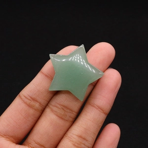 Macro view of a star-shaped green natural stone held in hand for DIY decor and healing