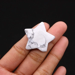 Close-up of a star-shaped polished white howlite stone with natural grey veins