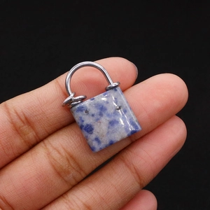 Detailed view of hand-held sodalite lock charm with silver metal hardware and blue texture