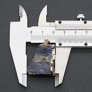 Lapis-Lazuli-Anhänger mit Goldrand und 2,2 cm Breite auf einem Messschieber gezeigt