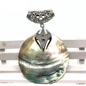 Natural round iridescent sea shell pendant with silver hollowed-out metal filigree hook
