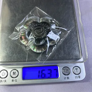 Détail du poids de 16,37g pour le pendentif fleur en nacre noire sculptée artisanale