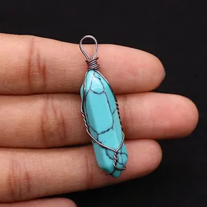 Detailed macro view of handmade copper wire wrapped turquoise hexagonal crystal pendant