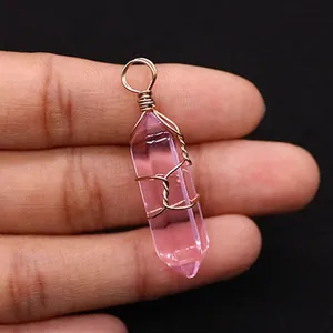 Detailed shot of pink crystal hexagonal pendant with handmade gold wire wrapping decoration